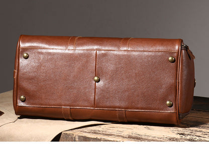 Brown leather weekender bag base with protective brass feet
