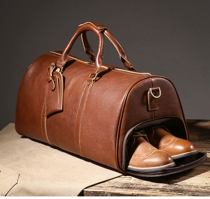 Brown leather weekender bag with shoe compartment open